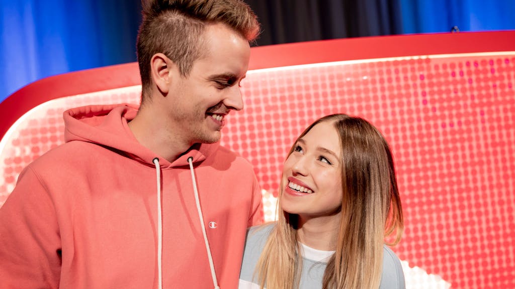 Das YouTuber-Paar Julian Claßen und Bianca Claßen schauen sich beim YouTube-Jahresrückblick 2018 im YouTube Space Berlin vor einem YouTube-Logo an.&nbsp;