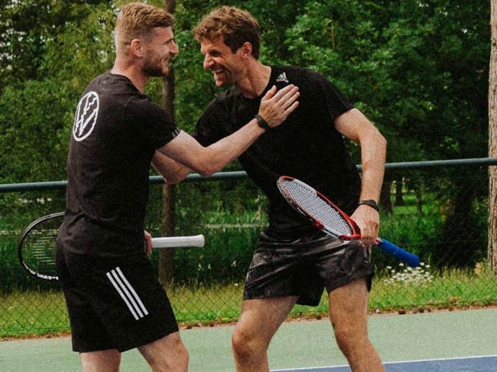 Timo Werner und Thomas Müller haben Spaß beim Tennis.