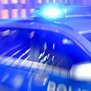 Ein Streifenwagen der Bundespolizei steht 2015 mit eingeschaltetem Blaulicht in Flensburg (Schleswig-Holstein) in der Ausfahrt einer Garage.