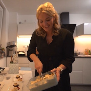 Gastgeberin Natalie steht am ersten Tag von Das perfekte Dinner in Düsseldorf (TV-Ausstrahlung: 27. Juni 2022) in ihrer Küche und bereitet Essen zu.