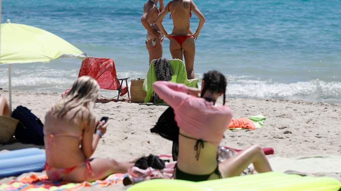 Frauen sonnen sich am Strand von Palmanova auf Mallorca. +++ dpa-Bildfunk +++