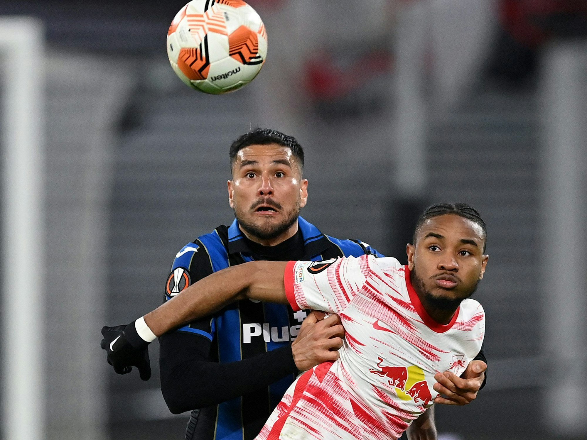 LEIPZIG, GERMANY - APRIL 07: Christopher Nkunku of RB Leipzig is challenged by Jose Luis Palomino of Atalanta B.C. during the UEFA Europa League Quarter Final Leg One match between RB Leipzig and Atalanta at Football Arena Leipzig on April 07, 2022 in Leipzig, Germany. (Photo by Stuart Franklin/Getty Images)
