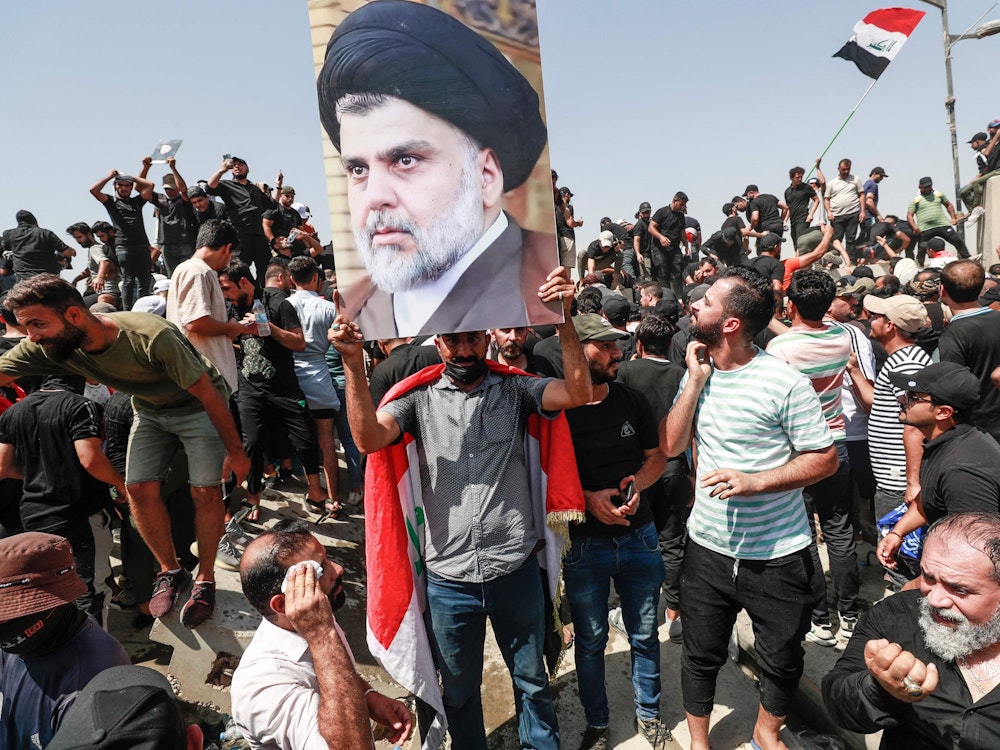 Unterstützer des irakischen Geistlichen Moqtada Sadr heben ein Porträt hoch, während sie gegen die Nominierung eines rivalisierenden Blocks zum Premierminister entlang der Al-Jumhuriya-Brücke (Republik) protestieren, die zur Hochsicherheitszone der Hauptstadt Bagdad führt.