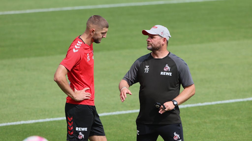 Steffen Baumgart nimmt sich Jeff Chabot im Training des 1. FC Köln zur Seite.
