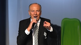Rolf Königs, Präsident von Fußball-Bundesligist Borussia Mönchengladbach. Auf diesem Foto ist der erfolgreiche Unternehmer am 30. Mai 2022 auf der Mitgliederversammlung im Borussia-Park zu sehen. Königs hält ein Mikrofon in der rechten Hand macht eine Geste mit seiner linken Hand.