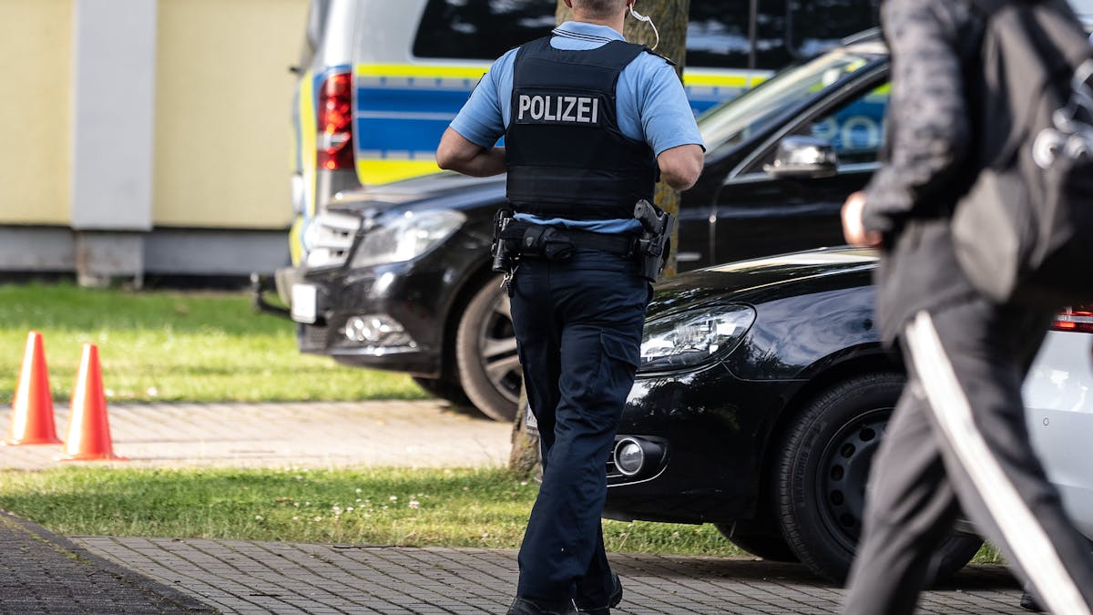 Ein Polizist steht vor Schulbeginn auf einem Parkplatz im nordhessischen Bad Arolsen.&nbsp;
