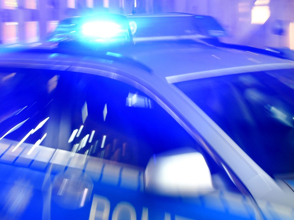 Das Symbolfoto zeigt einen Streifenwagen der Polizei, der mit eingeschaltetem Blaulicht auf der Straße steht.