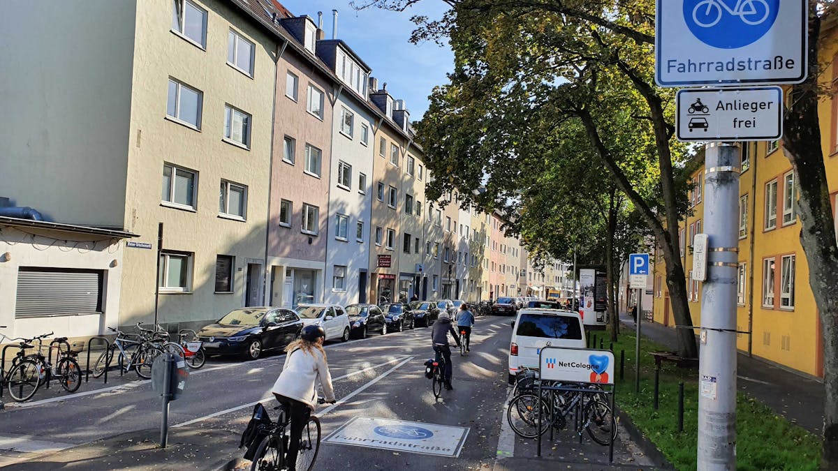 Radfahrerinnen und Radfahrer fahren über die neue Fahrradstraße an der Griechenpforte im Kölner Zentrum.
