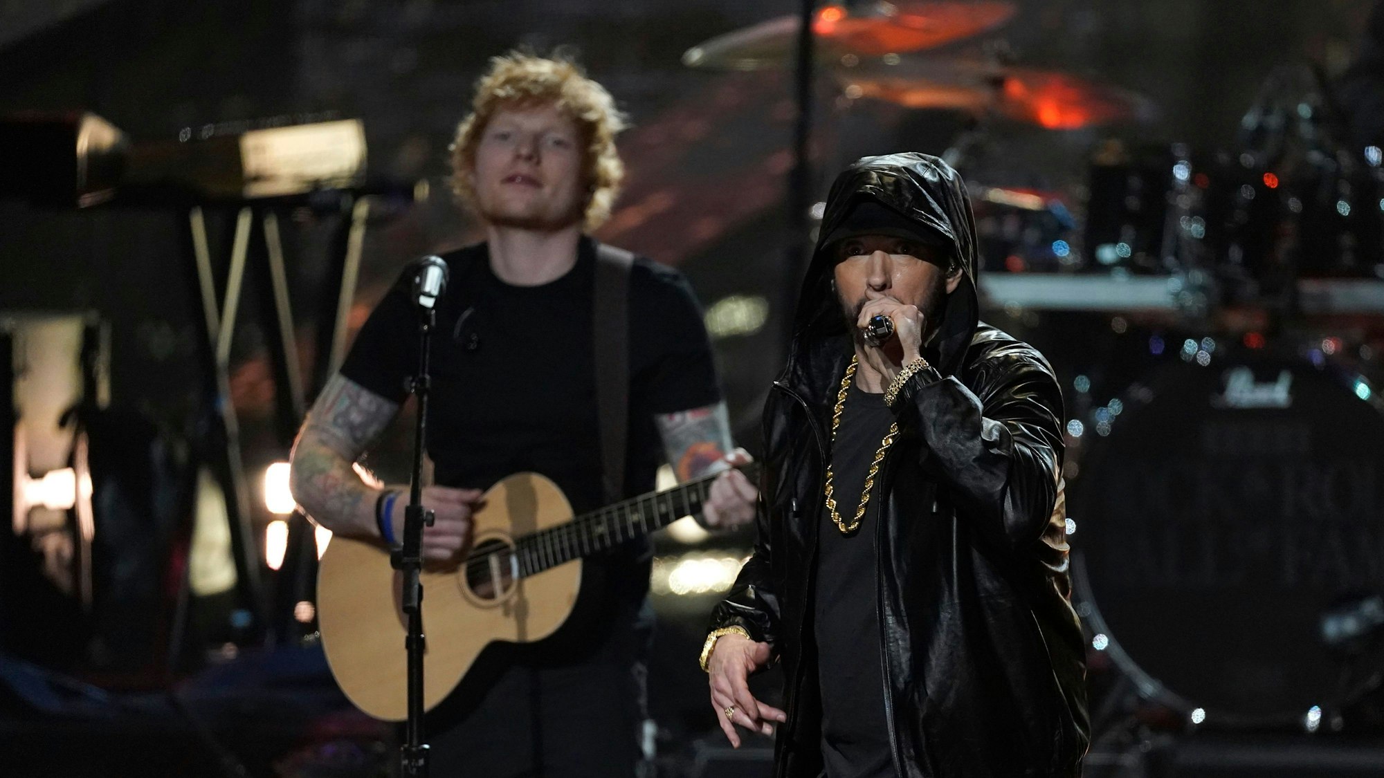 Ed Sheeran mit Gitarre steht links neben Rapper Eminem während der  Einführungszeremonie der Rock & Roll Hall of Fame 2022 im Microsoft Theater in Los Angeles.