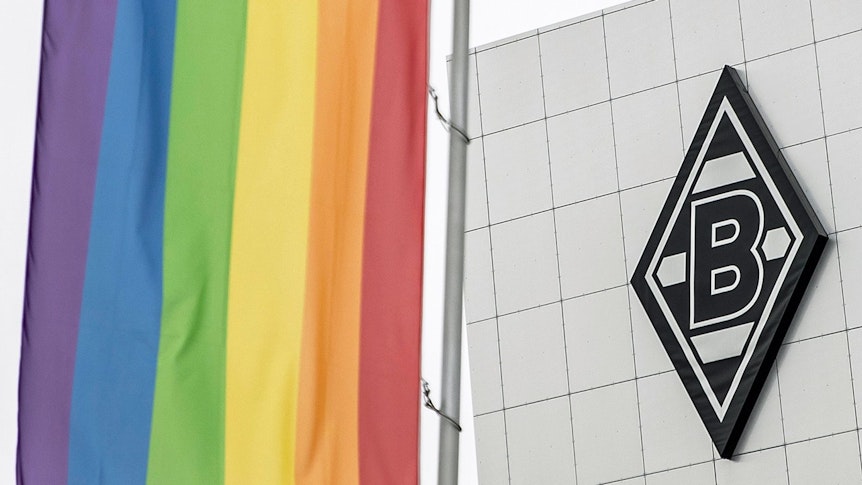 Bandera del arco iris en el parque Borussia, al fondo se puede ver el logo del club de fútbol Bundesliga FC Borussia Mönchengladbach en un edificio 