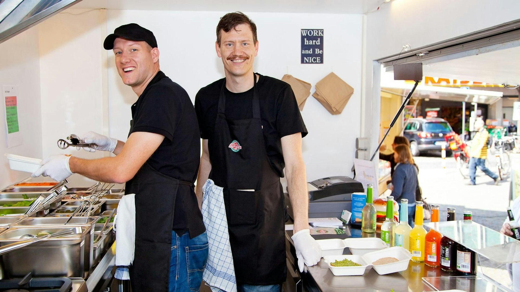 Mario Binder (L) und Ulrich Glemnitz stehen in einem Foodtruck von "Bunte Burger".