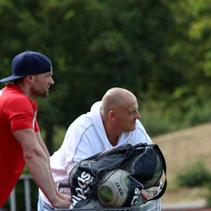 Der frühere ETSC-Trainer Hartmut Pitten lehnt beim Saisonauftakt gegen den SC Wißkirchen an einem Einkaufswagen, in dem die Ersatzbälle transportiert sind.