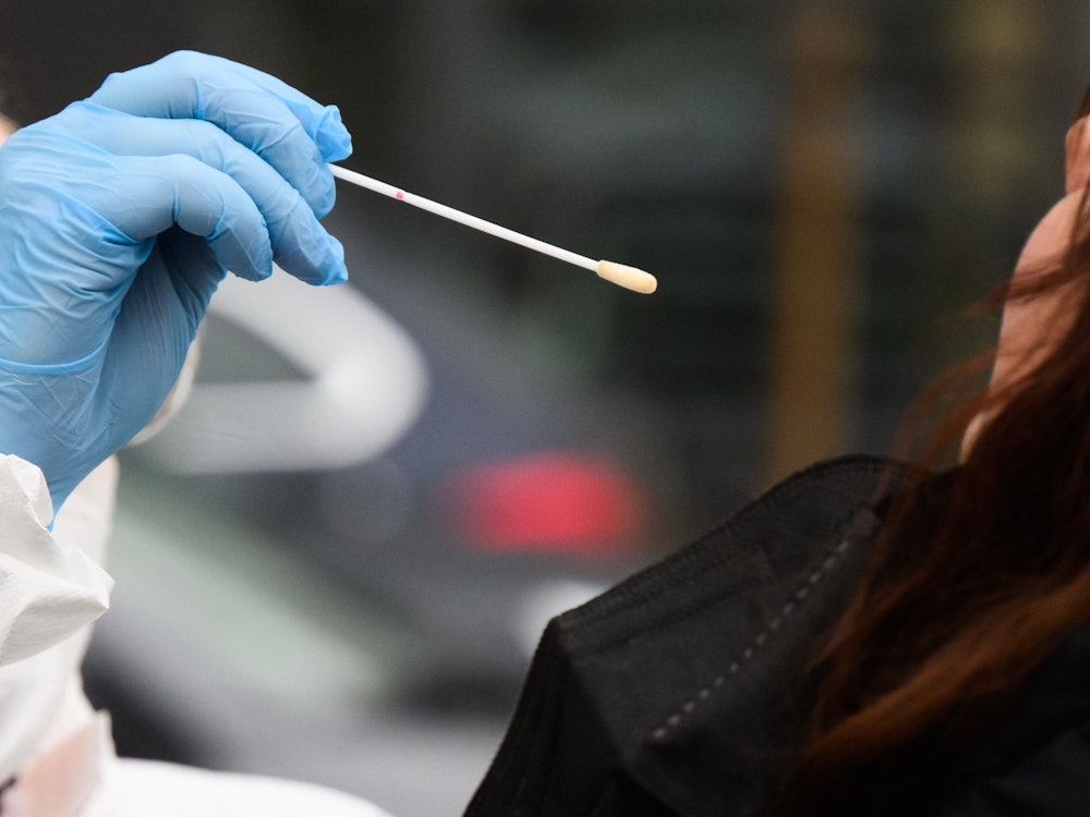Eine Hausärztin nimmt einen Abstrich von einer Patientin für einen PCR-Test auf das Corona-Virus vor einer Arztpraxis in der Region Hannover.