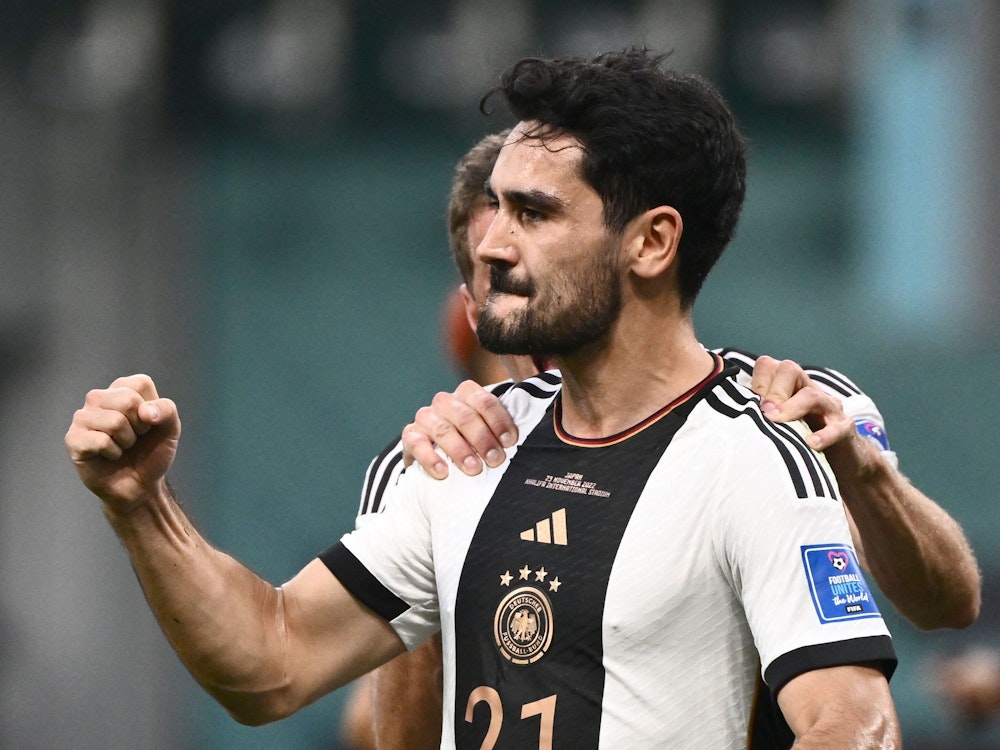 Germany's midfielder #21 Ilkay Gundogan celebrates after scoring his team's first goal from the penalty spot during the Qatar 2022 World Cup Group E football match between Germany and Japan at the Khalifa International Stadium in Doha on November 23, 2022. (Photo by Jewel SAMAD / AFP)