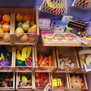 Obst und Gemüse aus Holz für den Kaufladen in einem Spielzeuggeschäft.