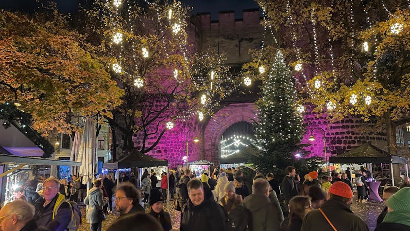 Weihnachtliche Beleuchtung und viele Besucher und Besucherinnen vor der Eigelsteintorburg