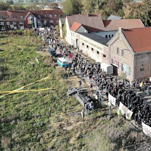 Bei einer Demonstration in Lützerath ziehen mehrere Hundert Teilnehmer mit Banner durch das Dorf.