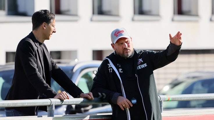 Christian Keller und Steffen Baumgart unterhalten sich während einer Trainingseinheit des 1. FC Köln am Geißbockheim.