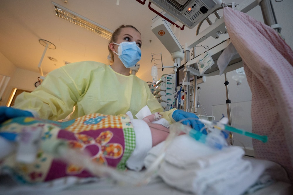 Eine Pflegekraft versorgt einen mit dem Respiratory Syncytial Virus (RS-Virus oder RSV) infizierten Patienten auf der Kinderstation des Olgahospitals des Klinikums Stuttgart.  Wegen der Atemwegserkrankung von Kleinkindern werden in manchen Krankenhäusern viele Operationen durchgeführt.