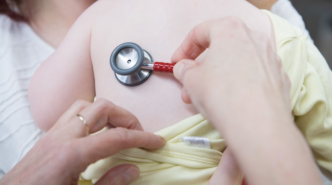 Eine Kinderärztin untersucht ein einjähriges Mädchen mit einem Stethoskop.&nbsp;