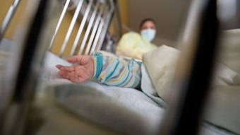 Ein Kind, von dem nur der Arm zu erkennen ist, liegt in einem Krankenhausbett. (Symbolbild).
