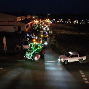 Mit Lichterketten geschmückte Traktoren fahren durch Wißkirchen.&nbsp;