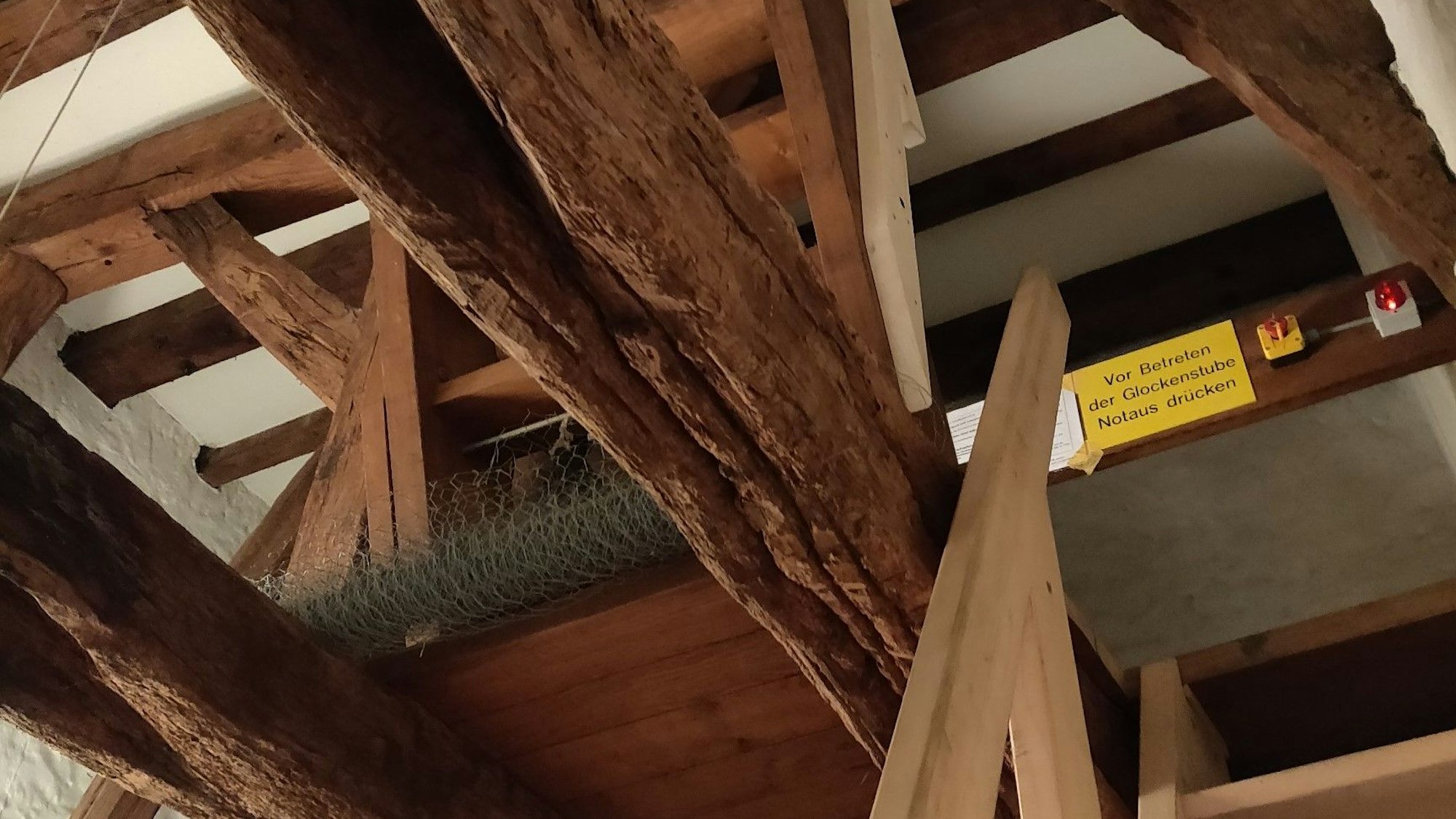 Dicke Holzbalken und schmale Leitern führen in den Turm empor.