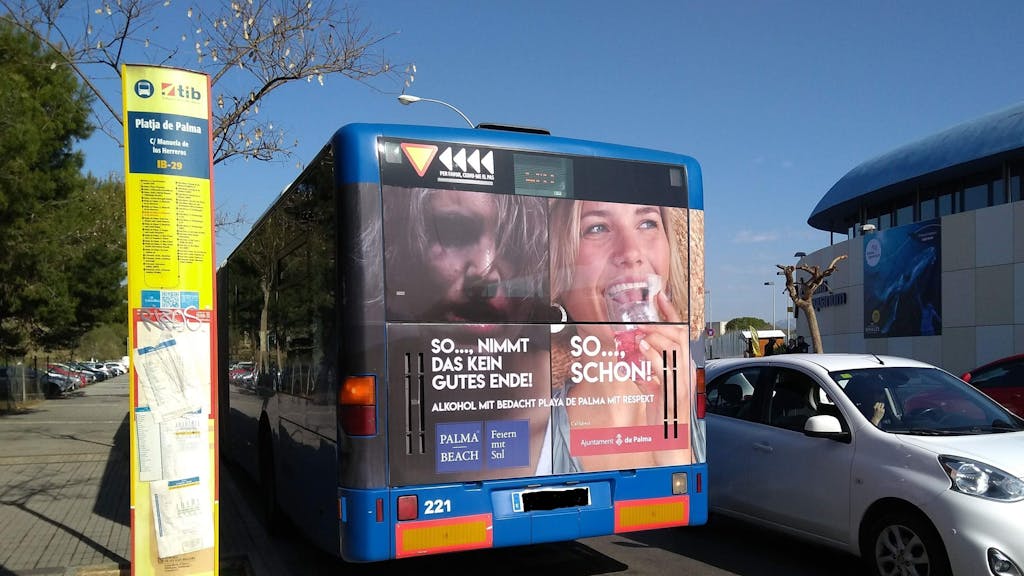 Ein Stadtbus steht in Palma de Mallorca an einer Bushaltestelle.