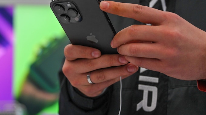 Eine Person hält ein iPhone 14 in den Händen.