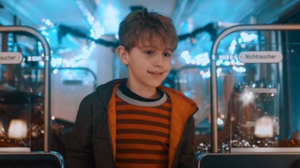Der kleine Leon geht im Weihnachts-Video der KVB durch einen Zug, der weihnachtlich geschmückt ist.