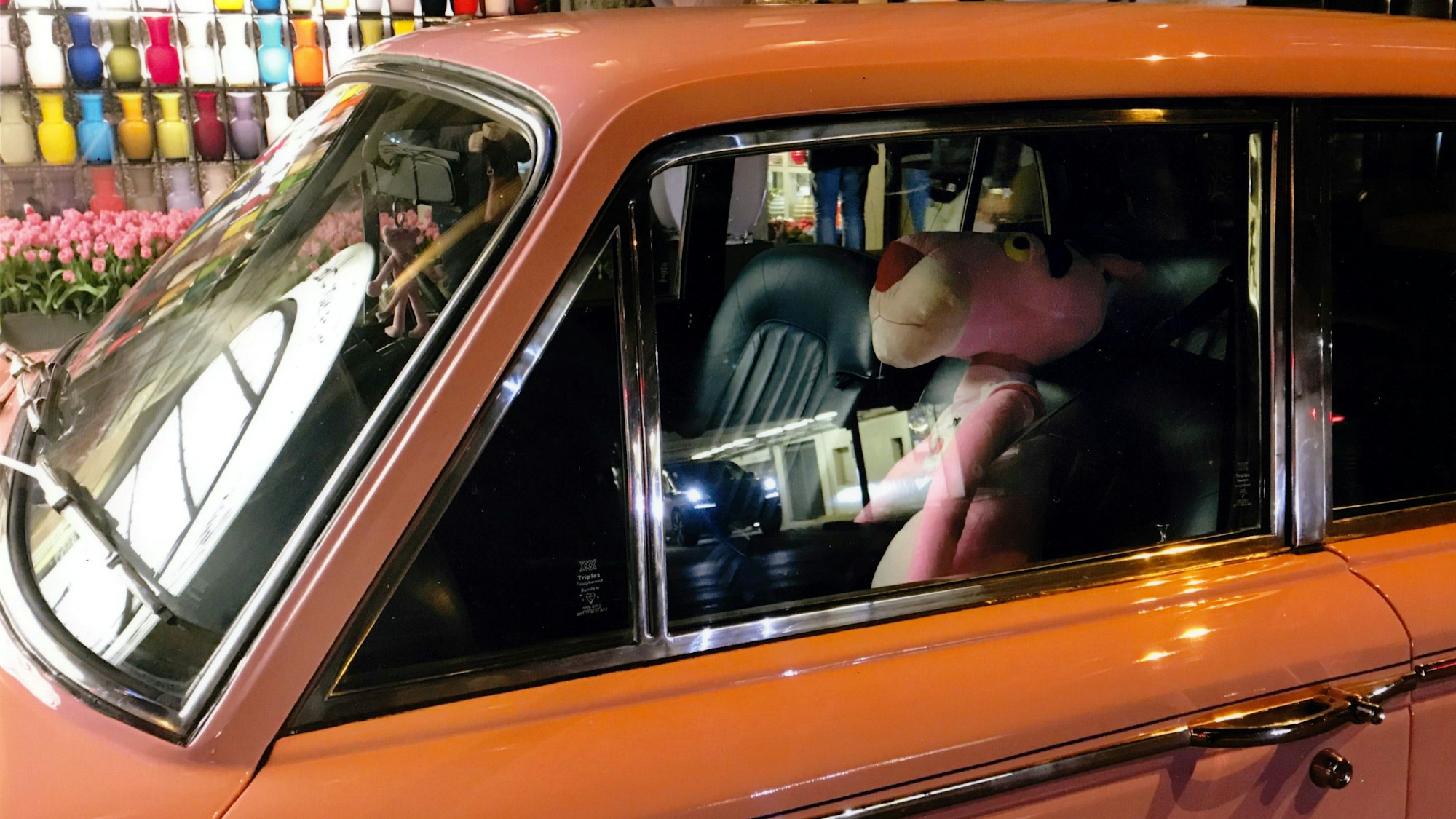 Eine Puppe von Paulchen Panter sitzt auf dem Fahrersitz einer Limousine.