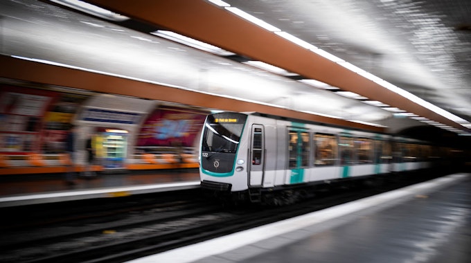 Ein Metro-Zug der Pariser Linie 9 fährt in einen Bahnhof ein.