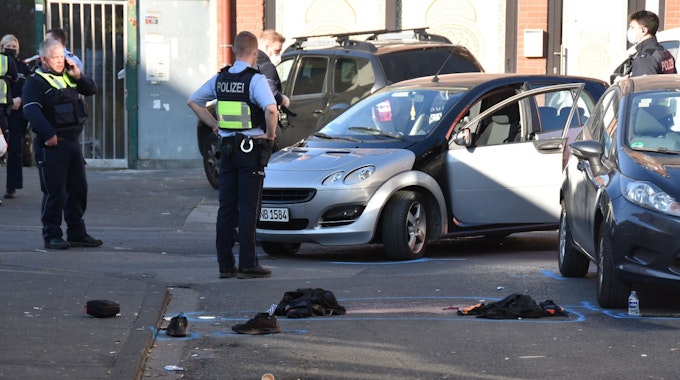 Polizisten stehen an der Bamberger Straße vor einem Auto, aus dem ein Mann gezerrt wurde.