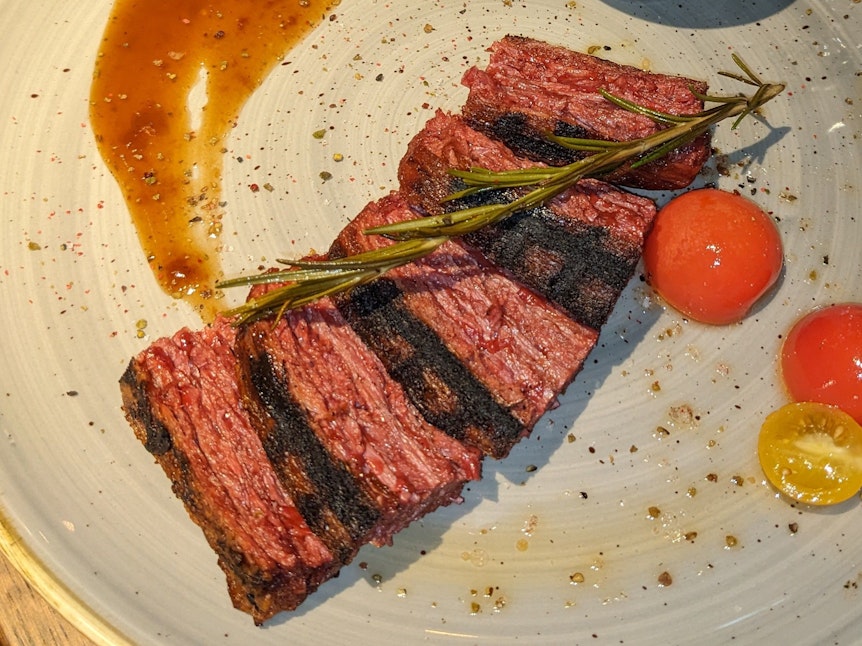 Das aufgeschnittene, vegane Steak liegt auf einem Teller. Optisch erinnert es stark an das Original vom Rind.