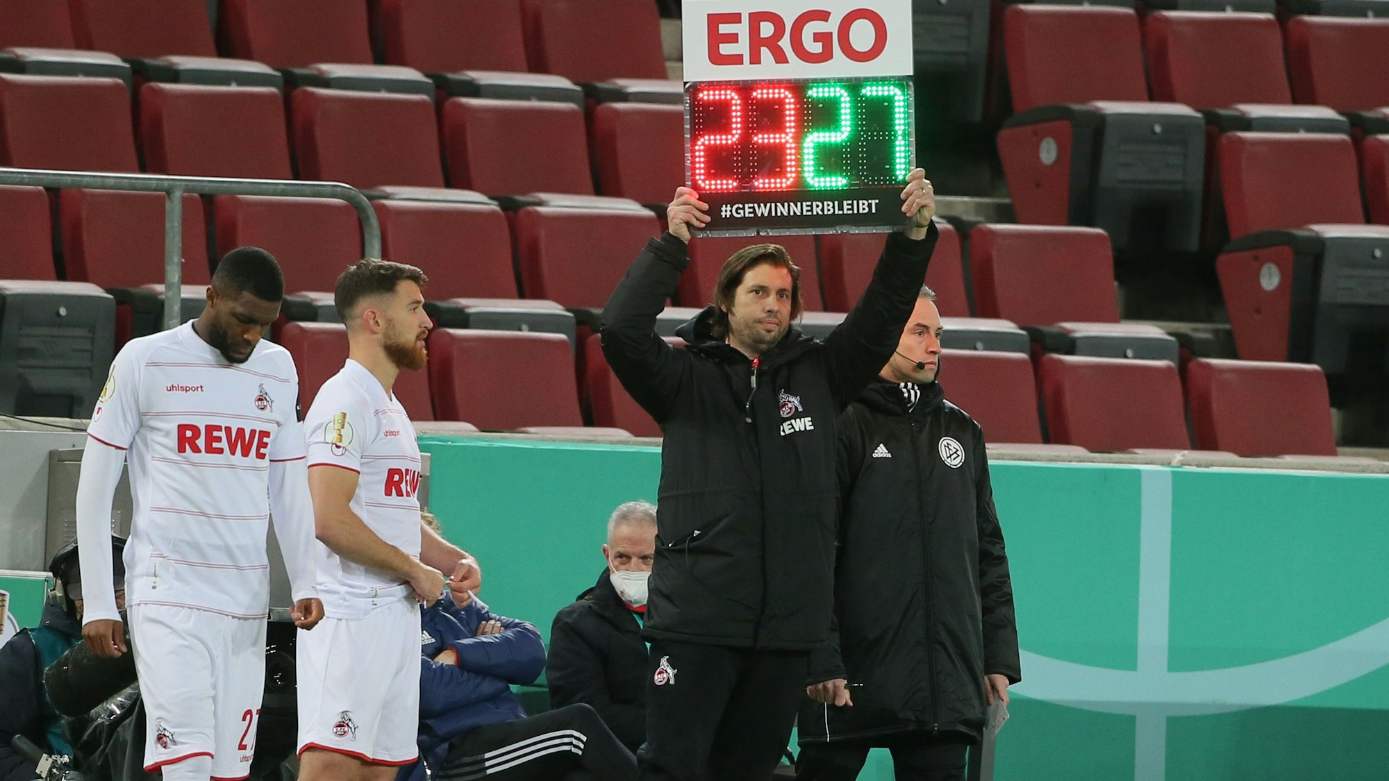 Im DFB-Pokal-Spiel des 1. FC Köln gegen den Hamburger SV zeigt Marius Laux die Einwechslungen von Anthony Modeste und Jan Thielmann an.