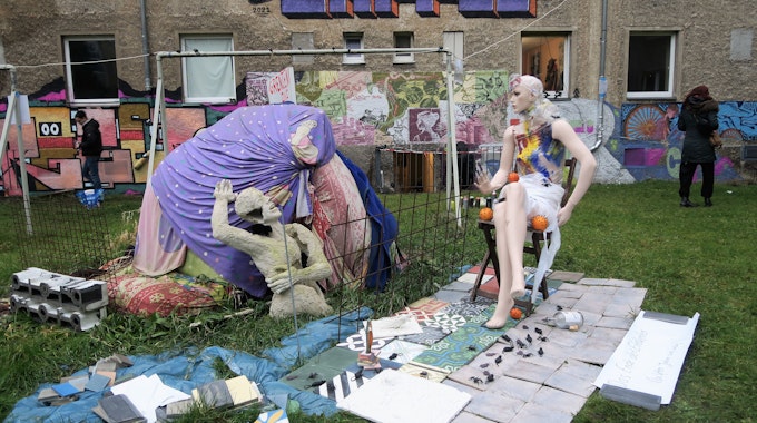 Die Skulptur "Grenzen auf" von Rolf Hartung steht im Innenhof des Wohnquatiers auf einer grünen Wiese.