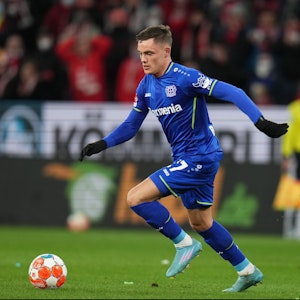 Florian Witz dribbelt im Trikot von Bayer Leverkusen mit dem Ball am Fuß.