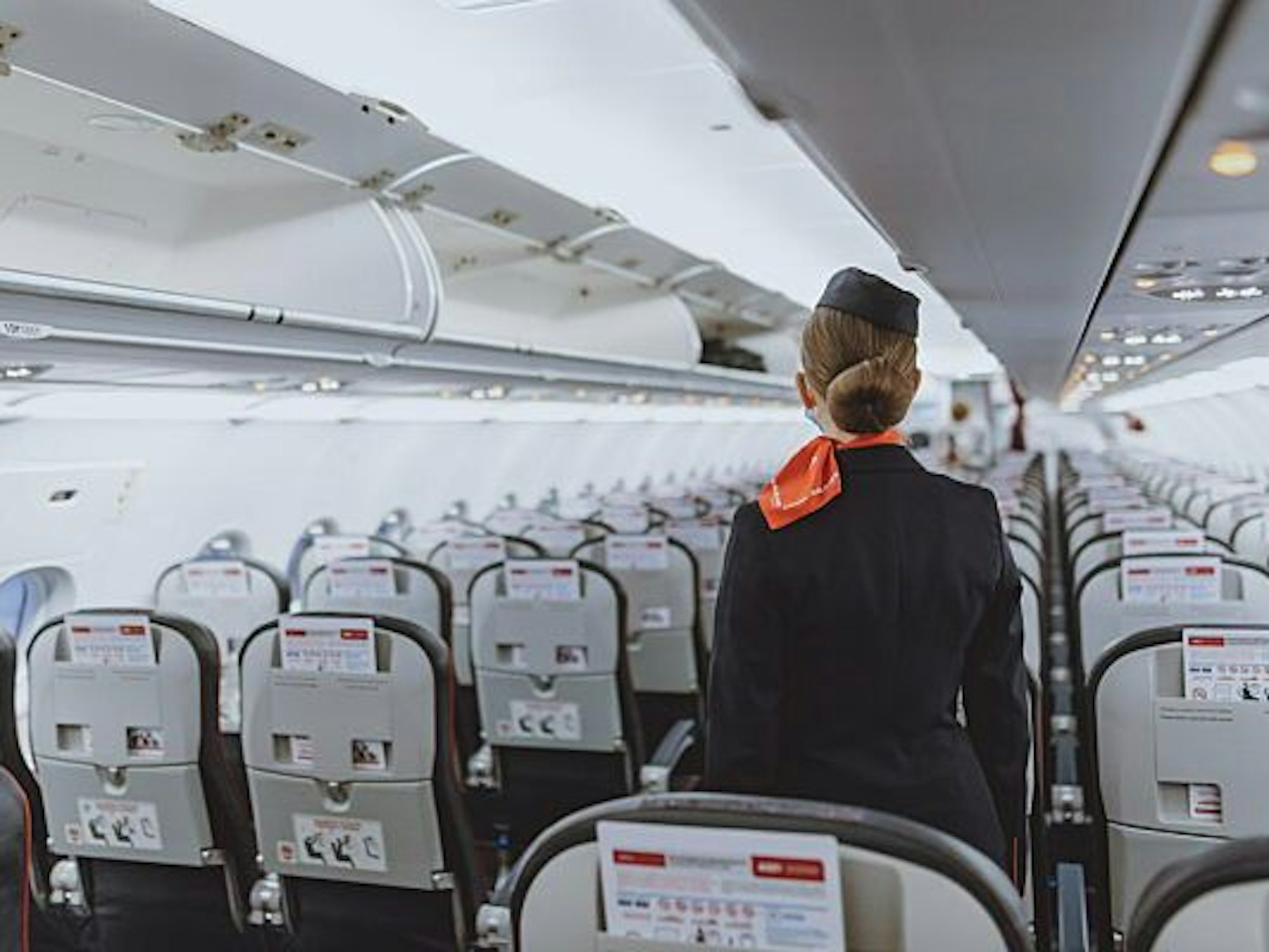 Eine Stewardess in einer Passagierkabine.