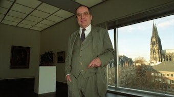 Museumsdirektor Rainer Budde steht vor einem Fenster mit Blick auf den Kölner Dom
