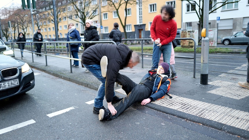 20. Januar 2023: Zwei Autofahrer zerren einen Aktivisten weg, der sich auf die Aachener Straße gesetzt hatte.