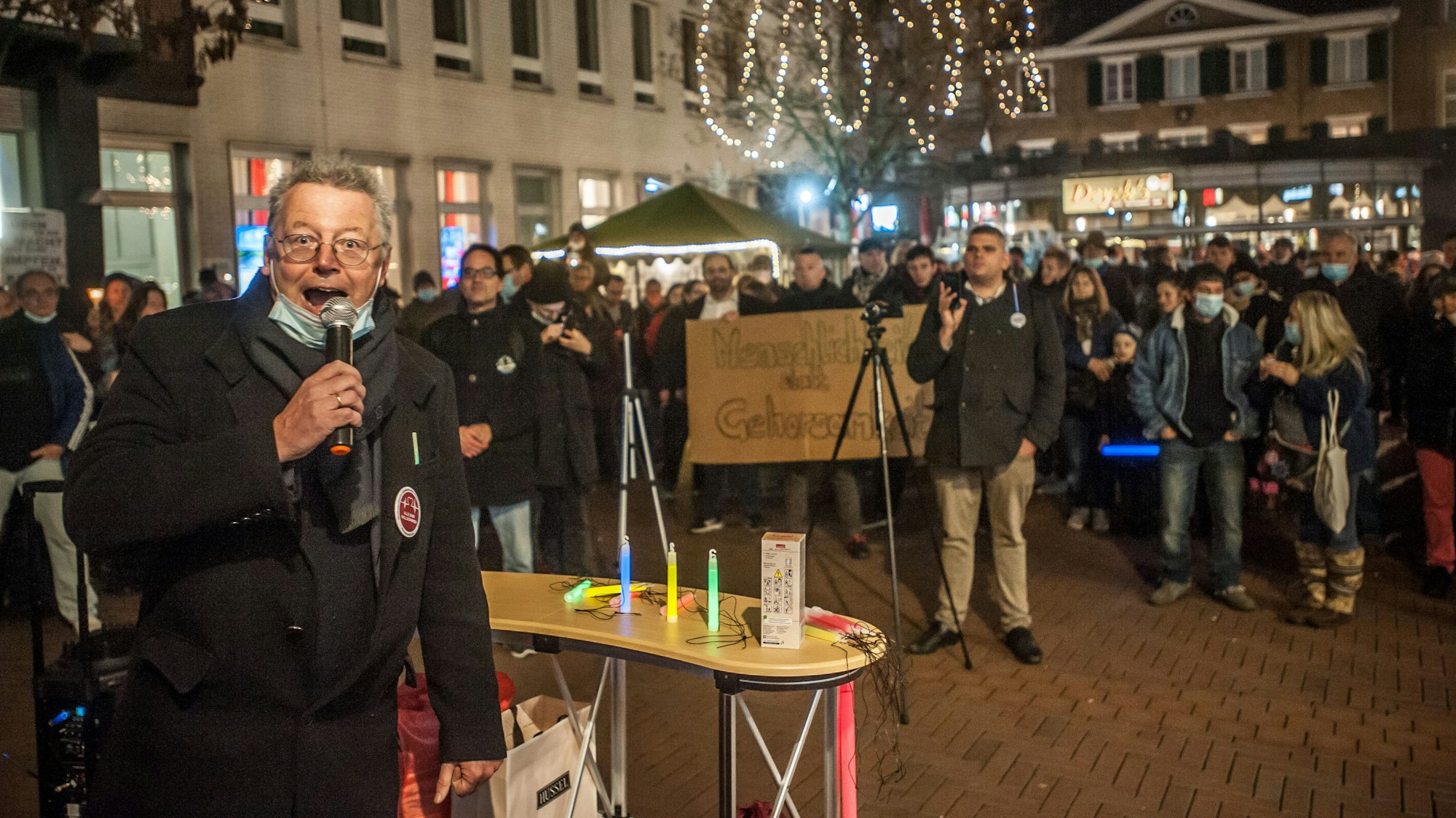 Der Rechtsextremist und Rechtsanwalt Markus Beisicht (links)spricht in ein Mikrofon und schaut in die Kamera. Hier wird er im Januar 2022 vom Neonazi Alexander Kurth (beige Hose) bei einer Demonstration gefilmt.