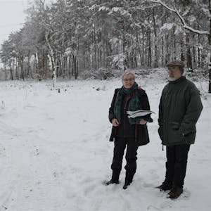 Friede Röcher und Ulrich Meisen vor dem zugeschneiten Naturwald.