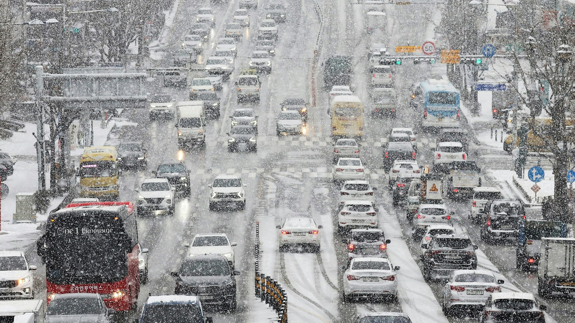 Fahrzeuge fahren im Schnee in Suwon, Südkorea.