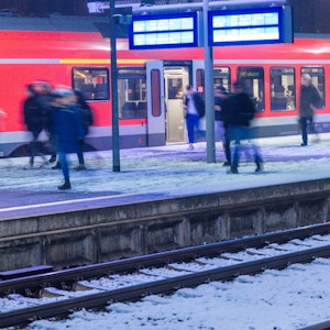 Fahrgäste steigen an einem Bahnhof aus einem Regionalzug.