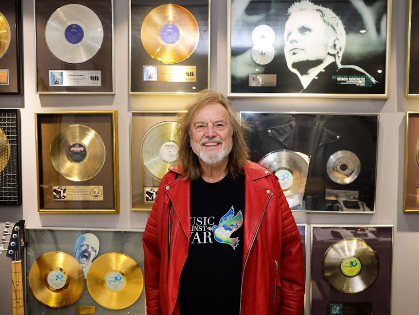 Dieter Dierks steht in seinem Büro in Pulheim vor vielen goldenen Schallplatten.