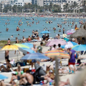 Menschen baden und sonnen sich am Strand von Palma de Mallorca im Juli 2022. Das „Forbes Magazine“ kürte Mallorca zum besten Reiseziel für 2023. Deshalb werden für den Sommer mehr US-amerikanische Reisende erwartet.