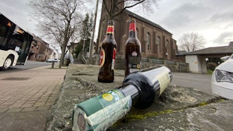 Vor der Kirche in Brühl-Schwadorf liegen Glasflaschen. Das Foto haben wir gestellt.