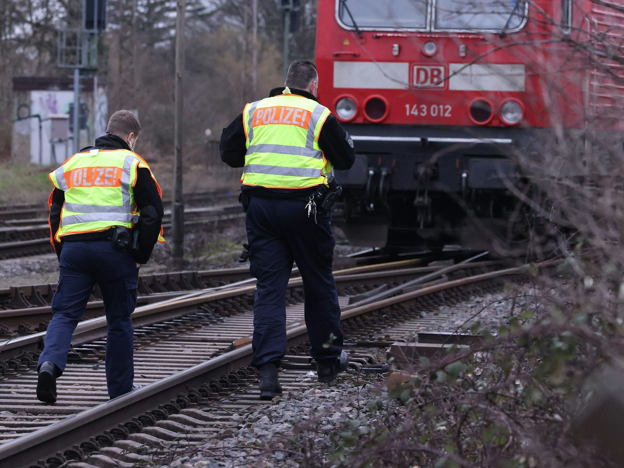 Zwei Polizisten gehen am 3. Februar 2023 an einer Lok auf einer Bahnstrecke vorbei. Wo genau sich der tödliche Unfall ereignet hat, ist immer noch unklar.