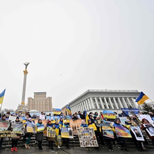 Angehörige von ukrainischen Kriegsgefangenen halten Poster und Portraits in Kiew.