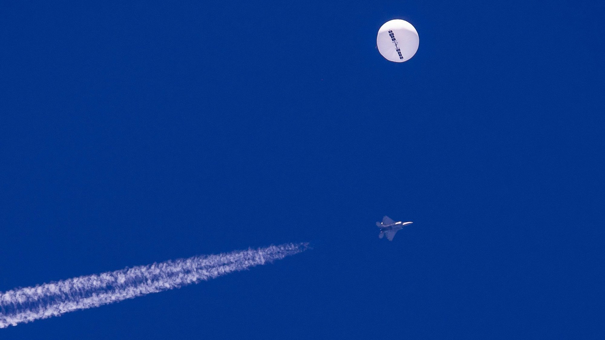 Auf diesem von Chad Fish zur Verfügung gestellten Bild schwebt ein großer Ballon über dem Atlantischen Ozean vor der Küste von South Carolina. Darunter sind ein Kampfjet und seine Kondensstreifen zu sehen. Der Ballon wurde von einer infrarotgesteuerten Luft-Luft-Rakete des Typs AIM-9X Sidewinder von einem F-22-Kampfflugzeug aus einer Höhe von 58.000 Fuß (etwa 17,7 km) in der Nähe von Myrtle Beach abgeschossen und faszinierte die Himmelsbeobachter in dem bevölkerungsreichen Gebiet, das wegen seiner kilometerlangen Strände, die Rentner und Urlauber anziehen, als Grand Strand bekannt ist.